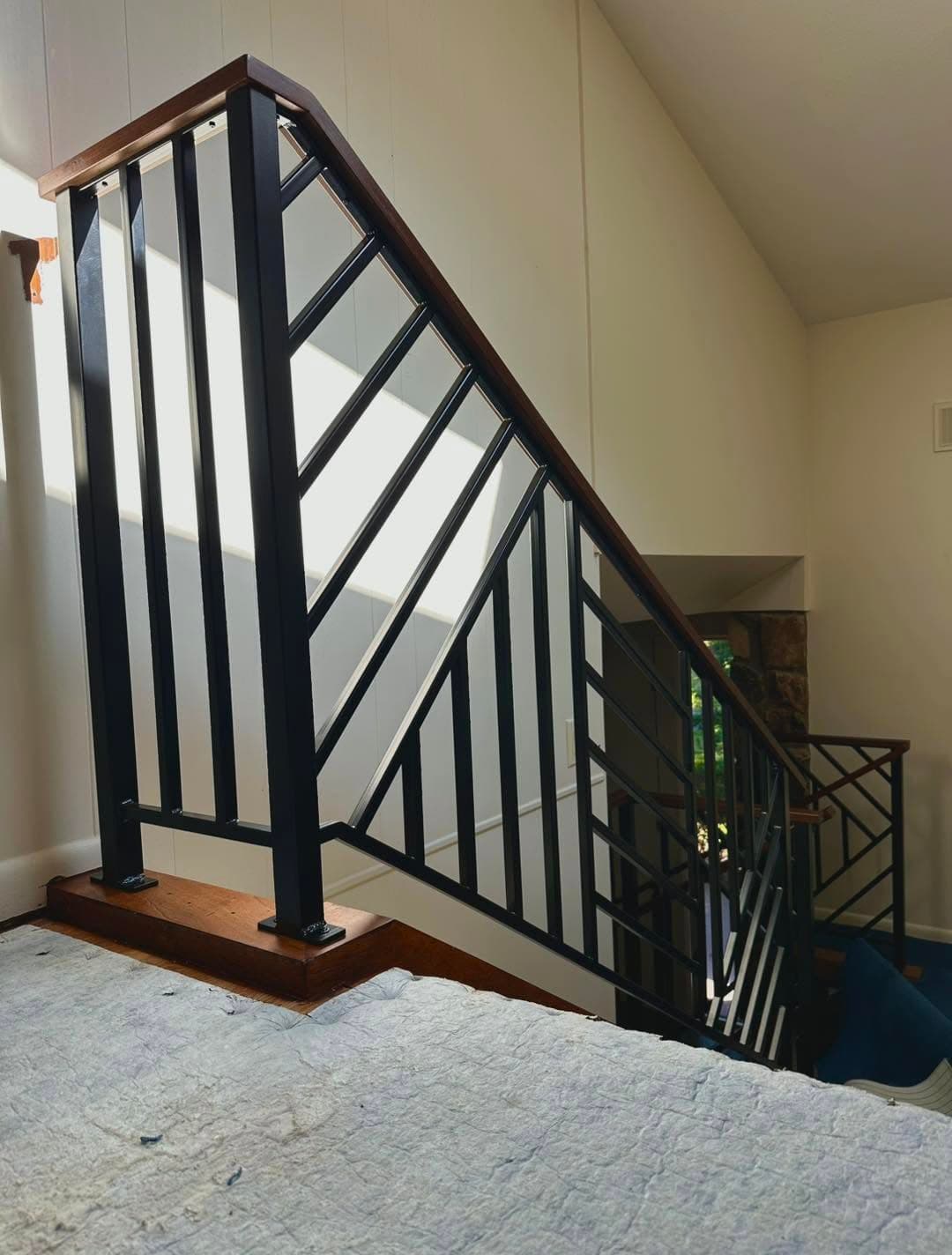 Interior stair railing with chevron baluster pattern